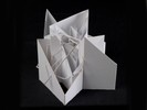 Photograph of white model with many extruded and intersecting planes.