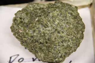 A green crystalline rock hand sample.