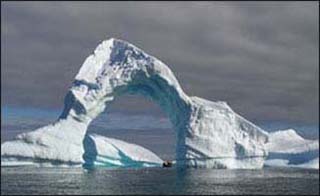 Arch of ice over the Antarctic ocean.