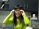 Photo of a student trying on eyeglasses.