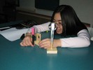 Photo of a student arranging and looking through lenses.