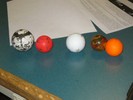 Photo of five balls of approximately the same size but made up of different materials (metal, rubber, etc.).