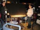Photo of students shining a powerful light on the ball rolling on the curved ramp.