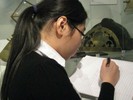 Photo of a student sketching one of the instruments in the display.