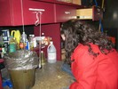 Photo of a student observing a simple pendulum consisting of a metal weight hanging from a drawer handle.