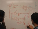 A student draws a circuit schematic for his final project.