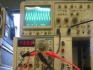 An oscilloscope displays the sinusoidal waveform of a whistling sound.