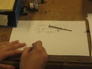 A student draws a few circuit schematics.
