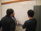 Two students discuss design parameters with Prof. Bales.