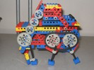 A Lego robot with three pairs of legs.