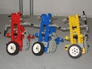 A Lego robot with three tall triangular-framed units.