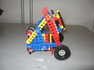 A triangular-framed robot, with wheels on two sides.