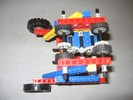 A triangular-framed robot, with wheels on two sides.