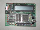 A PCB with various chips, Ethernet jack, and digital display.