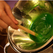 A student stirs a bowl of green goop.