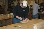 A student plots a curve on his hull model.