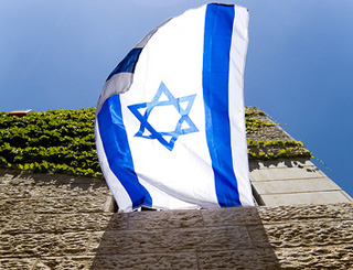 An Israeli flag flies from an open window.