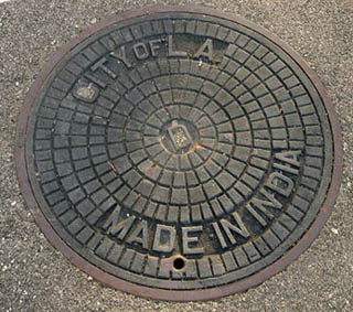 Manhole cover that reads City of L.A. in the upper half, Made in India in the lower half.