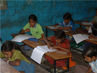 Photo of school-aged children in class.