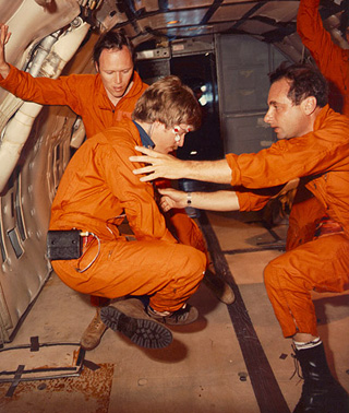 Larry Young spins Charles Oman during a test under weightless conditions.