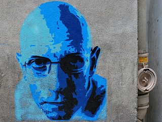 A photograph of a street art portrait of Michel Foucault.