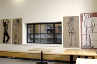 A photo of four body drawings hung on the wall.