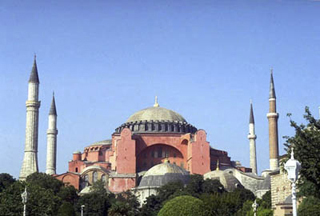 A large brick Byzantine cathedral, now a museum,  with dome and four minarets.