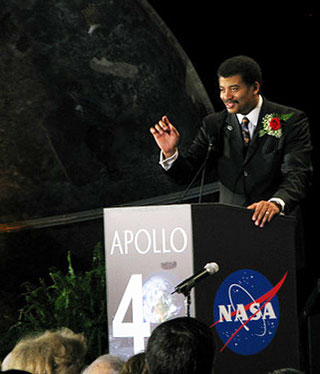 A photo of Neil deGrasse Tyson speaking at the National Air and Space Museum.