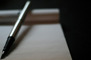 Photograph of pen and writing pad.