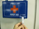 Photo of a first aid sign seen through a lens.