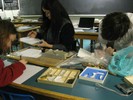 Photo of students taking notes at a lab table.