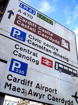 A road sign with directions in English and Welsh.