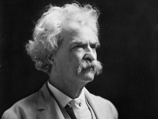 Black and white portrait of Mark Twain in shadow.