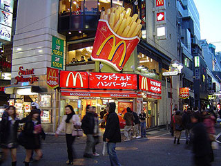 A photo of a McDonald's in Tokyo, Japan with passersby in the foreground.