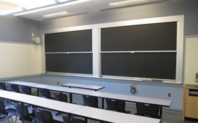 This photo shows the classroom for this course, which has seating for 22 in three rows of tables and movable chairs.