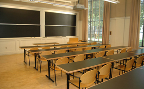 A classroom with tables and chairs for 30 students.