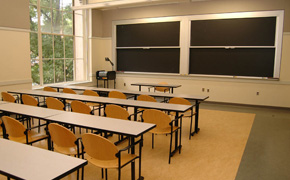 A medium-sized classroom with several blackboards.