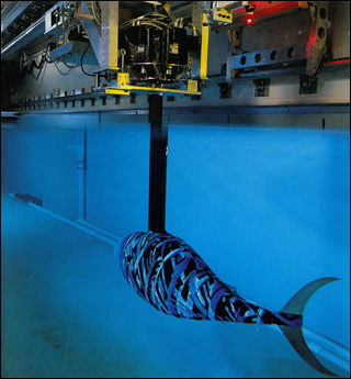 A robotic tunafish swimming in a large tank.