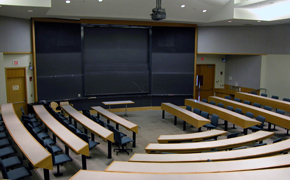 A view of the classroom from the back, facing the blackboards in the front of the room.