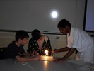 Students work together to produce an image using the parts of a telescope.