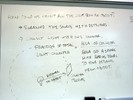 Notes on a whilteboard explain collecting light from an object.