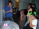 Students hold slides up to their eyes looking at diffraction emissions.