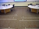 White strips of tape on the floor denote energy levels.
