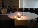 A lit bulb sits on a table.