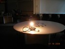 A lit bulb sits on a table.