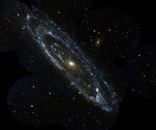 A blue spiral of stars form the Andromeda Galaxy set against a black background filled with multi-colored stars.
