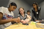 A photo of girls working on building a camera.